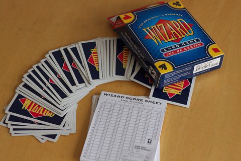 Cards, box, and scorecard of the trick-taking game Wizard .