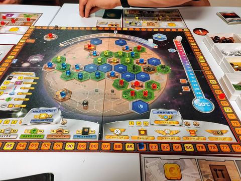 Board game Terraforming Mars showing board with tiles and colored cubes placed.