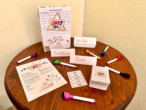 The Just One party game box, rules, cards, and pieces