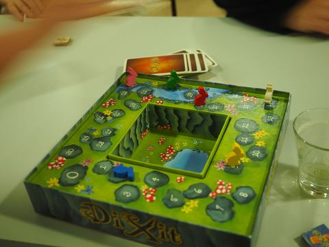 The scoreboard of a six-player game of Dixit played at a special board game camp in Kirkkonummi, Finland on an evening in October 2023. The bunny of the blue player is resting on its side to mark that the blue player has passed the 30 points mark and is already on the second round of the scoreboard.